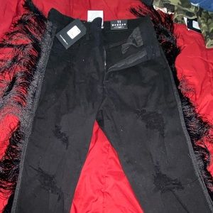 Black distressed jeans with ruffles in side